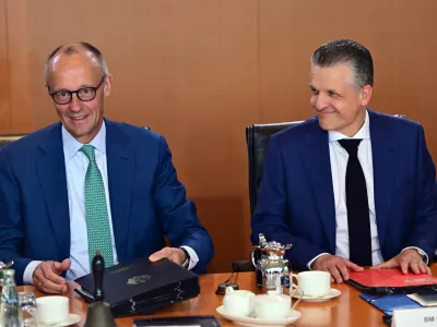 German Chancellor Friedrich Merz, left, and Thorsten Frei, Head of the Federal Chancellery and Federal Minister for Special Tasks attend the cabinet meeting at the chancellery in Berlin, Germany, Wednesday, July 22, 2026. (Sebastian Gollnow/dpa via AP)