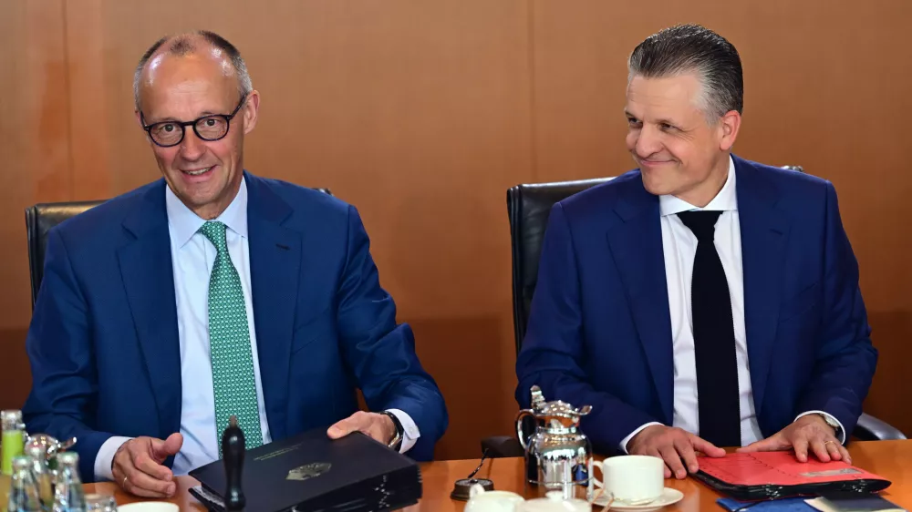 German Chancellor Friedrich Merz, left, and Thorsten Frei, Head of the Federal Chancellery and Federal Minister for Special Tasks attend the cabinet meeting at the chancellery in Berlin, Germany, Wednesday, July 22, 2026. (Sebastian Gollnow/dpa via AP)