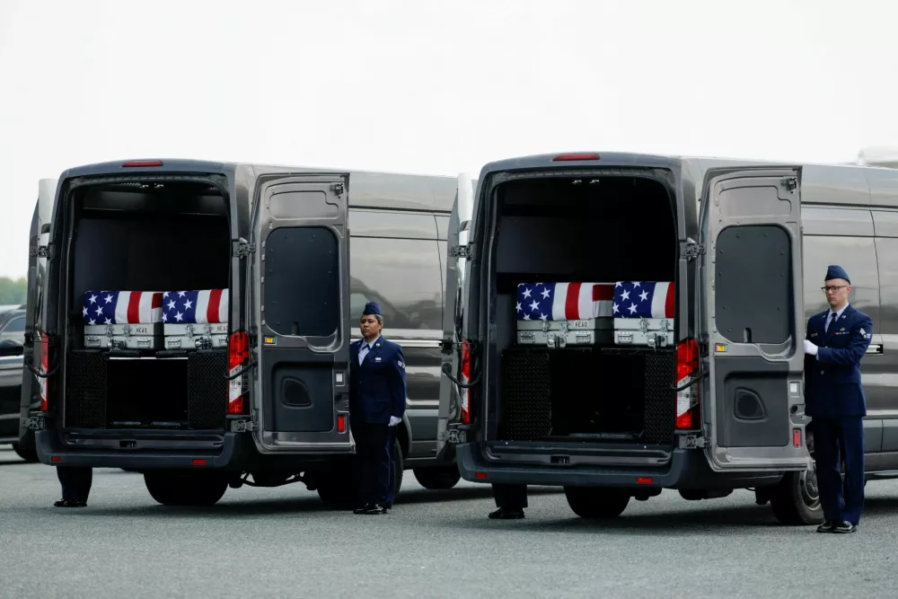 Transfer cases rest in transport vans during a dignified transfer of the remains of U.S. Army service members Army 1st Lt Tyler James Feehan, Sgt. Angel S. Rampersad, Pvt. Isabella Gonzales, killed during an attack on Muwaffaq Salti Air Base in Jordan, and Sgt. Michael Emmanuel Swinton, killed in action during a controlled detonation of a downed one-way unmanned aerial system at Erbil Air Base in Iraq, at Dover Air Force Base in Dover, Delaware, U.S., July 22, 2026. REUTERS/Evan Vucci   TPX IMAGES OF THE DAY