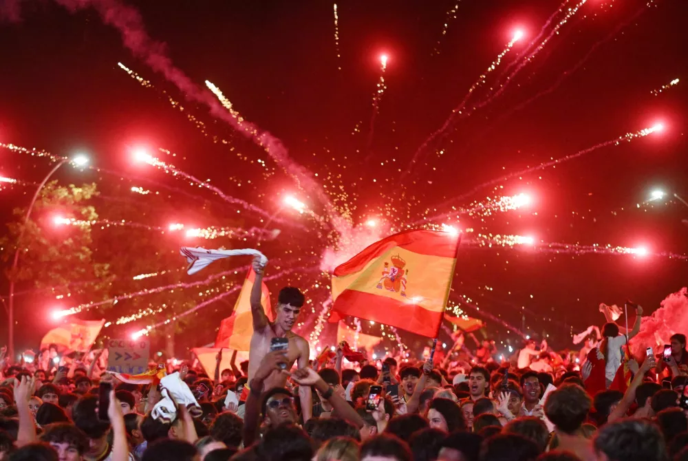 Soccer Football - FIFA World Cup 2026 - Final - Spain v Argentina - Fans gather in Lamine Yamal's hometown - Rocafonda, Spain - July 19, 2026 Spain fans celebrate their first goal as they watch the FIFA World Cup final between Spain and Argentina in Lamine Yamal's hometown - Rocafonda REUTERS/Lorena Sopena  TPX IMAGES OF THE DAY