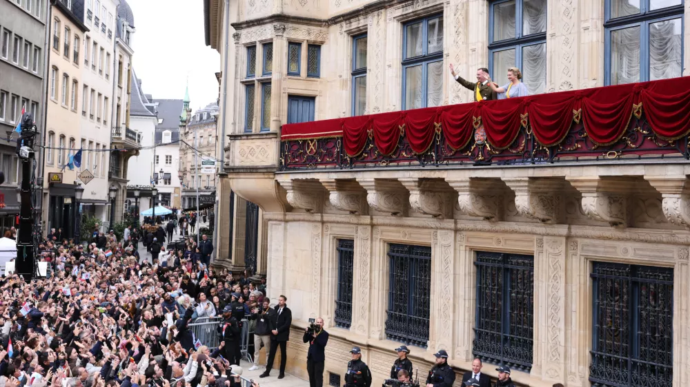 Luxembourg's Grand Duke Guillaume and Luxembourg's Grand Duchess Stephanie wave from the balcony of the Grand Ducal Palace in Luxembourg, Friday, Oct. 3, 2025. (AP Photo/Omar Havana)