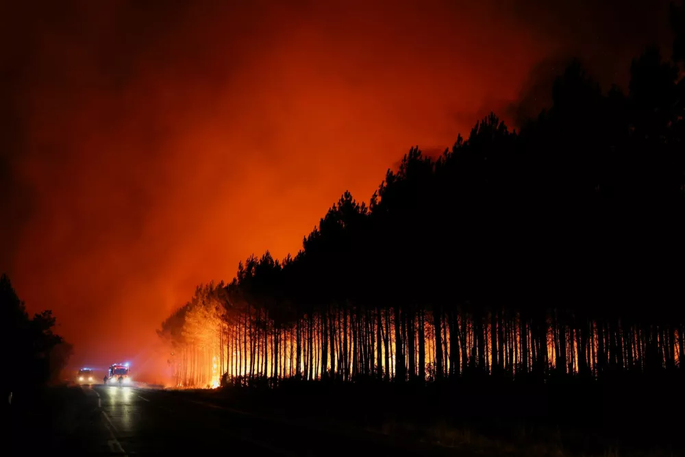 A wildfire burns in a forest area in the Gironde department amid worsening drought conditions following a heatwave and water shortages across much of France, July 22, 2026. REUTERS/Stephane Mahe
