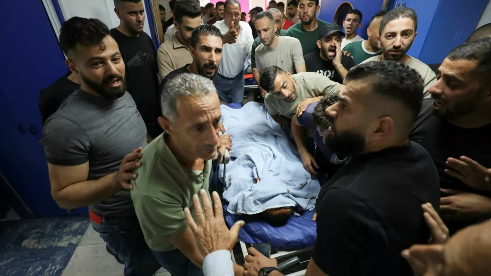 Palestinians gather around the body of a man who was killed during a confrontation with Israeli settlers, at a hospital in the Israeli-occupied West Bank city of Nablus, July 24, 2026.REUTERS/Nidal Eshtayeh