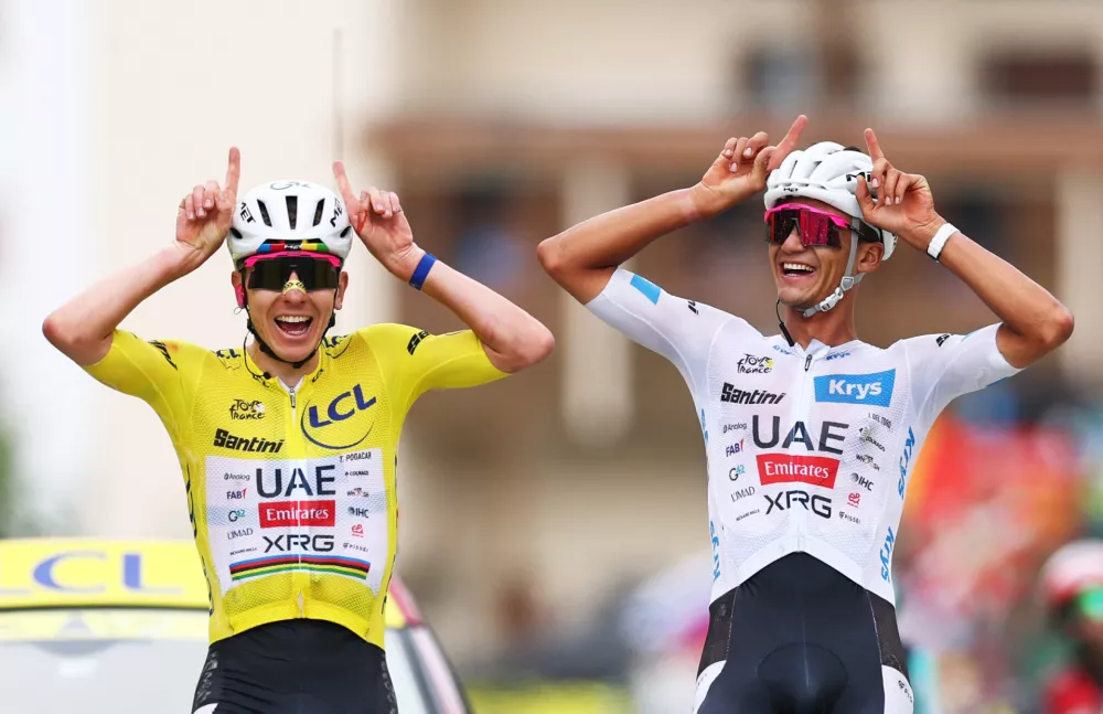 Cycling - Tour de France - Stage 20 - Le Bourg d'Oisans to Alpe d'Huez - Alpe d'Huez, France - July 25, 2026 UAE Team Emirates XRG's Tadej Pogacar wearing the yellow jersey and UAE Team Emirates XRG's Isaac Del Toro wearing the white jersey react at the end of stage 20 REUTERS/Gonzalo Fuentes