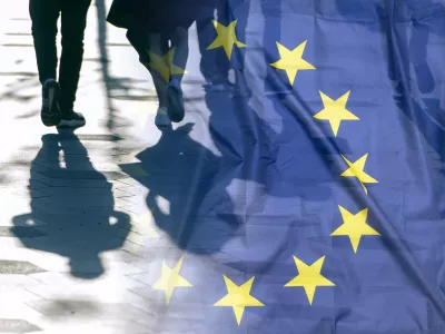 EU or European Union Flag and shadows of people, concept political picture