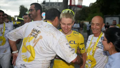 Slovenia's Tadej Pogacar, wearing the overall leader's yellow jersey, celebrates with his teammates after the last stage of the Tour de France cycling race with start and finish in Paris, Sunday, July 26, 2026. (AP Photo/Mosa'ab Elshamy)