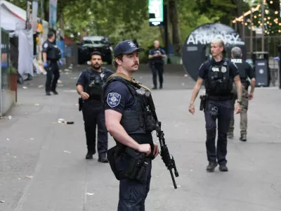 Police officers stand guard at a site after Seattle Police responded to what they described as a shooting with "multiple" victims at Seattle Center, which was hosting a Bite of Seattle food festival, in Seattle, Washington, U.S., July 26, 2026. REUTERS/Jason Redmond