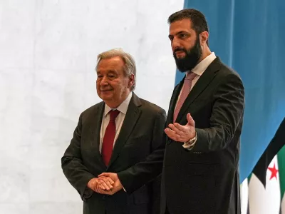 Syrian President Ahmad al-Sharaa, right, welcomes United Nations Secretary General Antonio Guterres at the Syrian presidential palace in Damascus, Syria, Saturday, July 25, 2026. (AP Photo/Omar Albam)