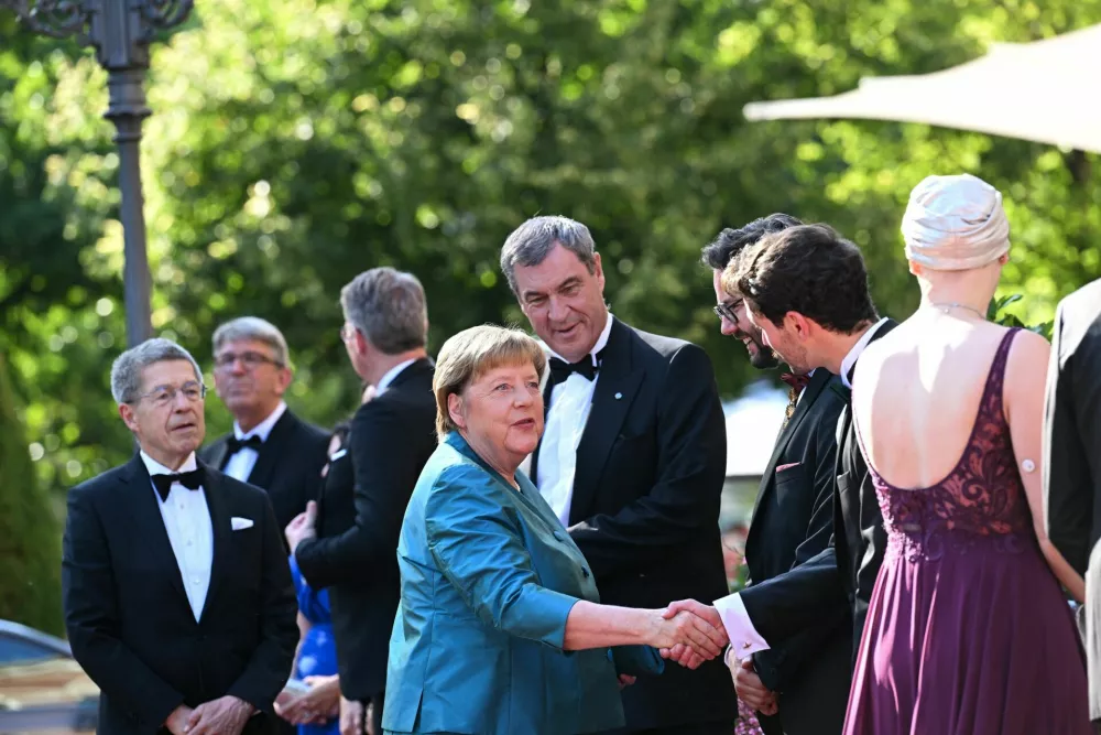 Former German Chancellor Angela Merkel, her husband Joachim Sauer and Minister-President of Bavaria Markus Soeder attend the opening of the Bayreuth Festival at the Richard Wagner Festival Hall, in Bayreuth, Germany July 25, 2026. REUTERS/Angelika Warmuth