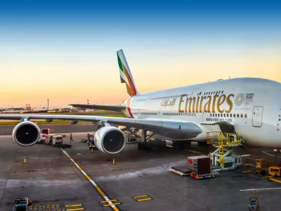 London, England - 05.05.2018: An Emirates Airbus A380-800 super jumbo aircraft waiting for passengers and loading at London Heathrow terminal 3 during sunset. The Airbus A380 is the world's largest passenger airliner.