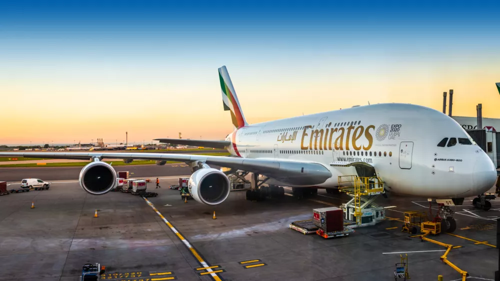 London, England - 05.05.2018: An Emirates Airbus A380-800 super jumbo aircraft waiting for passengers and loading at London Heathrow terminal 3 during sunset. The Airbus A380 is the world's largest passenger airliner.