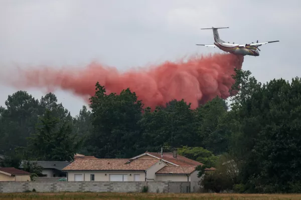 A plane drops fire retardant as efforts to battle wildfires continue amid drought conditions following a heatwave and water shortages across much of France, in Marcheprime, Gironde department, France, July 27, 2026. REUTERS/Florion Goga