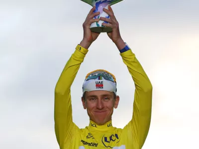 Cycling - Tour de France - Stage 21 - Paris, France - July 26, 2026 UAE Team Emirates XRG's Tadej Pogacar celebrates on the podium while wearing the yellow jersey after winning the Tour de France REUTERS/Gonzalo Fuentes