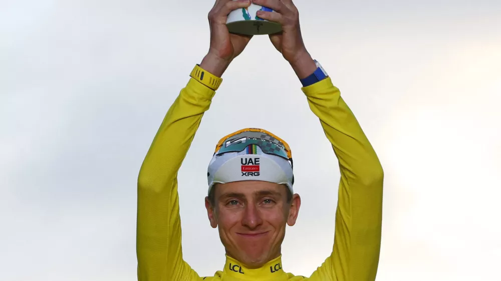 Cycling - Tour de France - Stage 21 - Paris, France - July 26, 2026 UAE Team Emirates XRG's Tadej Pogacar celebrates on the podium while wearing the yellow jersey after winning the Tour de France REUTERS/Gonzalo Fuentes