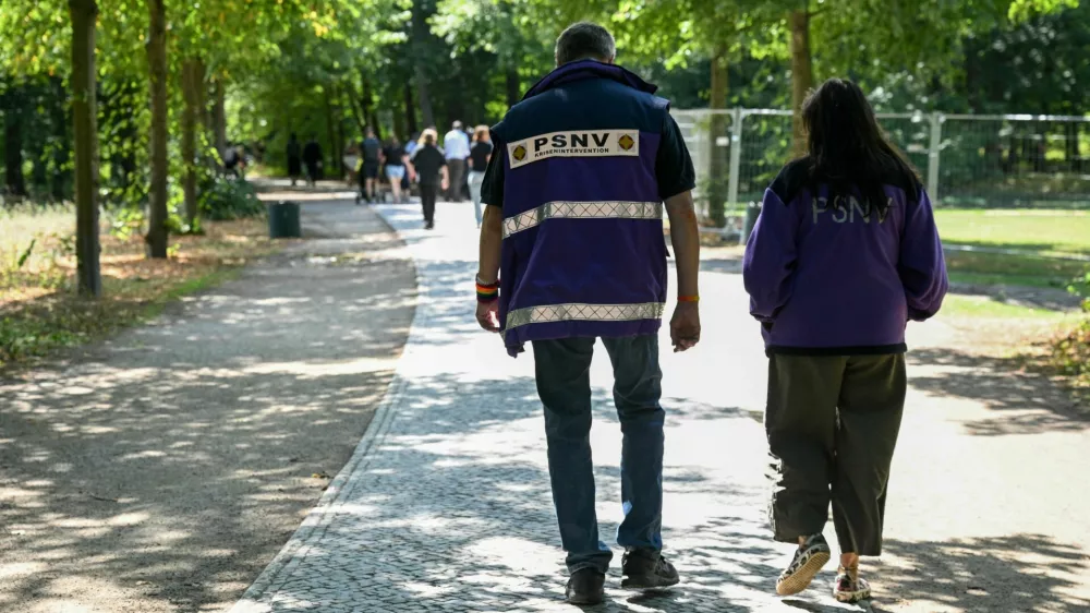 Care providers walk on Ahornsteig path in Tiergarten park, after a deadly attack in which a vehicle crashed into a crowd near Berlin's annual Christopher Street Day Pride parade on Saturday evening, leaving one dead and multiple others injured, in Berlin, Germany, July 27, 2026. REUTERS/Annegret Hilse