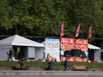 Cleanup continues at the Space Needle the day after a shooting at Seattle Center during the Bite of Seattle food festival, Monday, July 27, 2026. (AP Photo/Lindsey Wasson)