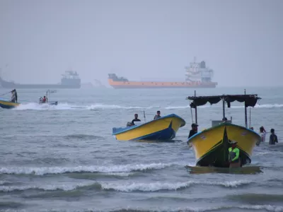 Small boats line the shore as cargo ships and other commercial vessels appear anchored in the Strait of Hormuz off Bandar Abbas, Iran, Monday, July 27, 2026. (Razieh Poudat/ISNA via AP)