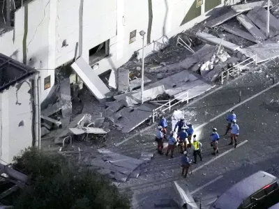 This aerial image shows rescue workers continue searching at the damaged AEON Mall after an earthquake in Kashima, Kumamoto prefecture, southern Japan, Tuesday, July 28, 2026. (Kyodo News via AP)