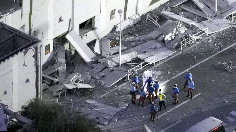 This aerial image shows rescue workers continue searching at the damaged AEON Mall after an earthquake in Kashima, Kumamoto prefecture, southern Japan, Tuesday, July 28, 2026. (Kyodo News via AP)