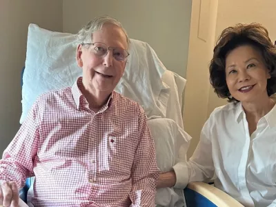 U.S. Senator Mitch McConnell (R-KY) sits with his wife, former United States secretary of labor Elaine Chao, while holding what appears to be the July 12 sports section of the Washington Post in a photograph released by his office in Washington, D.C., U.S. July 12, 2026. Office of Senator Mitch McConnell/Handout via REUTERS.  THIS IMAGE HAS BEEN SUPPLIED BY A THIRD PARTY