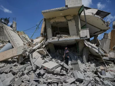 Hanan Qubaisi inspects her house destroyed in previous Israeli airstrikes in the town of Nabatiyeh, southern Lebanon, Wednesday, June 24, 2026, after a ceasefire between Israel and Hezbollah. (AP Photo/Bilal Hussein)