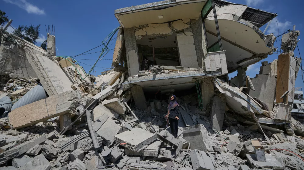 Hanan Qubaisi inspects her house destroyed in previous Israeli airstrikes in the town of Nabatiyeh, southern Lebanon, Wednesday, June 24, 2026, after a ceasefire between Israel and Hezbollah. (AP Photo/Bilal Hussein)