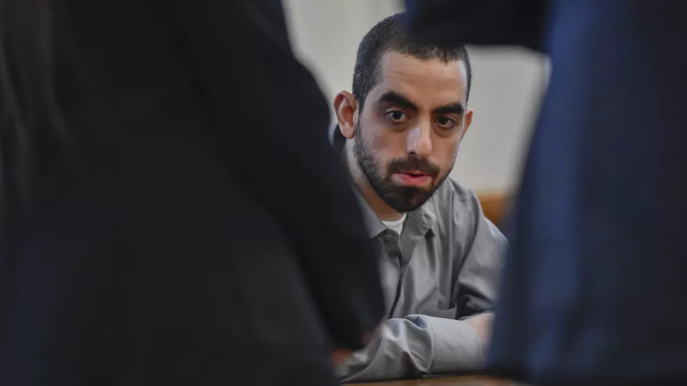 Hadi Matar, charged with severely injuring author Salman Rushdie in a 2022 knife attack, sits in Chautauqua County court after being found guilty on all counts in Mayville, N.Y., Friday, Feb. 21, 2025. (AP Photo/Adrian Kraus)