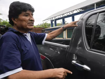 FILE - Former Bolivia's President Evo Morales points to a bullet hole on his car that he claims was the result of an assassination attempt, in Lauca N, Chapare region, Bolivia, Nov. 3, 2024, amid an ongoing political conflict with the government of President Luis Arce. (AP Photo/Juan Karita, File)