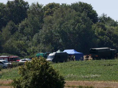 Members of the military and emergency services work near a crater left by an unidentified object that appears to be a Russian missile, Polish Prime Minister Donald Tusk said on Thursday, in a field near the village of Tarnawa-Kolonia in Lublin province, Poland, July 30, 2026. REUTERS/Kuba Stezycki