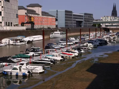 A man walks on a pier as boats lie in the partially dried-up Rheinauhafen harbour basin during low water levels on the Rhine river in Cologne, Germany, July 30, 2026. REUTERS/Thilo Schmuelgen / Foto: Thilo Schmuelgen