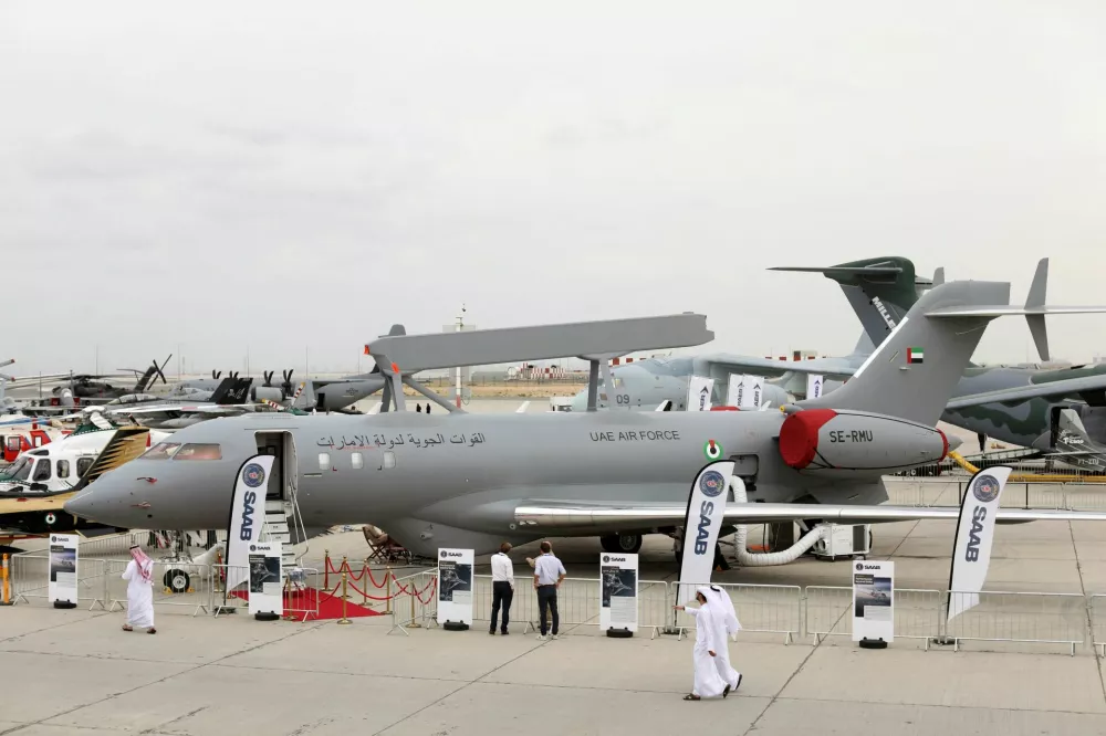 FILE PHOTO: Visitors walk past a GlobalEye aircraft, manufactured by Saab Technologies, on static during the fifth day of Dubai Air Show in Dubai, United Arab Emirates November 21, 2019. Picture taken November 21, 2019. REUTERS/Christopher Pike/File Photo