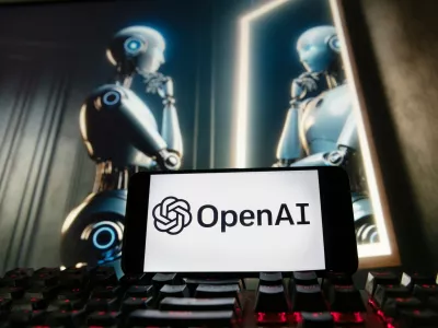 FILE - The OpenAI logo is displayed on a cellphone with an image on a computer monitor generated by ChatGPT's Dall-E text-to-image model, Dec. 8, 2023, in Boston. (AP Photo/Michael Dwyer, File)