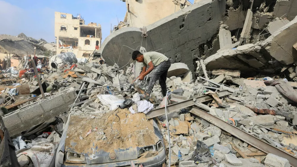 A Palestinian boy inspects the site of Wednesday's Israeli strike on a house whose residents were pre-warned by the Israeli military to evacuate, in Gaza City, July 30, 2026. REUTERS/Dawoud Abu Alkas