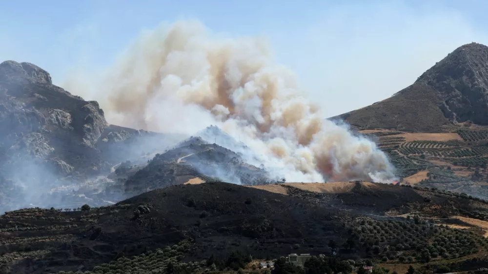 A wildfire burns in a canyon near Asomatos village on the island of Crete, Greece, July 30, 2026. REUTERS/Stringer