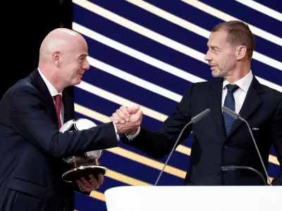FILE PHOTO: Soccer Football - 50th Ordinary UEFA Congress - Brussels Expo, Brussels, Belgium - February 12, 2026 UEFA president Aleksander Ceferin and FIFA president Gianni Infantino shake hands during the event REUTERS/Benoit Tessier/File Photo