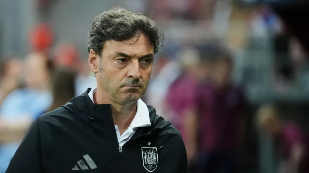 FILE - Spain's coach Santi Denia walks prior to a quarter final soccer match between Spain and England at the European U-21 Championship at the Anton Malatinsky Stadium, in Trnava, Slovakia, Saturday, June 21, 2025. (AP Photo/Petr David Josek, file)