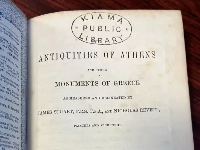 In this photo provided by Catherine Taylor a page of the book "Antiquities of Athens," stamped by a library, is shown on Thursday, July 30, 2026, after its return in Kiama, Australia, an estimated 150 years late. (Catherine Taylor via AP)