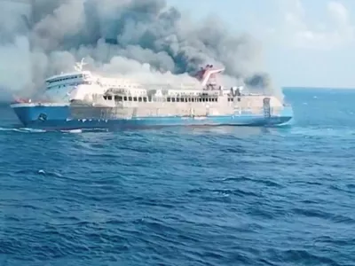 Plumes of smoke rise from a ferry which caught fire off Indonesia's Madura island, according to statement by the Indonesian search and rescue agency, in this screengrab obtained from a video, East Java province, Indonesia, August 2, 2026. National Search and Rescue Agency (BASARNAS)/Handout via REUTERS  ATTENTION EDITORS - THIS IMAGE HAS BEEN SUPPLIED BY A THIRD PARTY. MANDATORY CREDIT.
