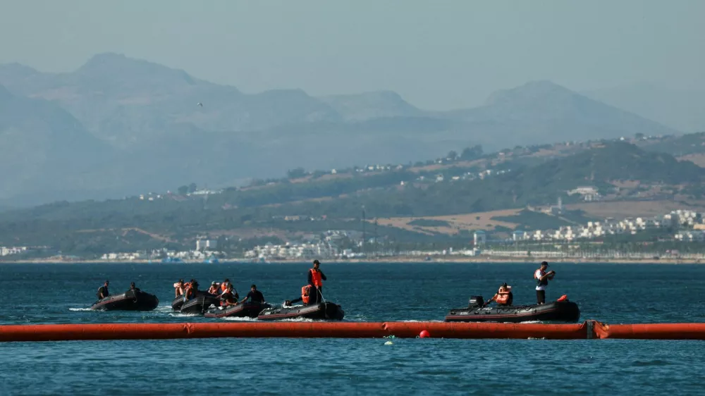 Members of the Royal Moroccan Navy patrol on the Moroccan side of the floating barrier off the border with Morocco, following mass crossings of migrants on foot and by sea from Morocco into Spanish territory, as seen from Ceuta, Spain, August 2, 2026. REUTERS/Violeta Santos Moura   TPX IMAGES OF THE DAY