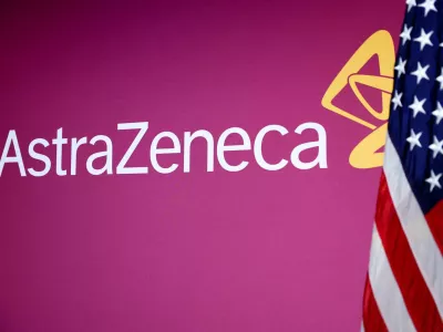 FILE PHOTO: A U.S. flag stands next to the AstraZeneca logo during a signing event for documents related to a manufacturing site investment at the Meridian International Center in Washington, D.C., July 21, 2025. REUTERS/Umit Bektas/File Photo