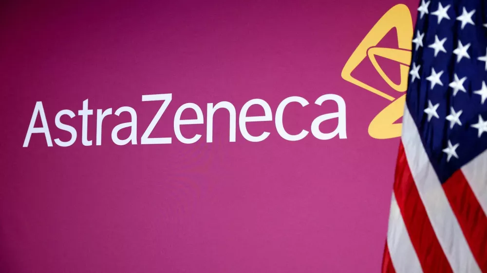 FILE PHOTO: A U.S. flag stands next to the AstraZeneca logo during a signing event for documents related to a manufacturing site investment at the Meridian International Center in Washington, D.C., July 21, 2025. REUTERS/Umit Bektas/File Photo