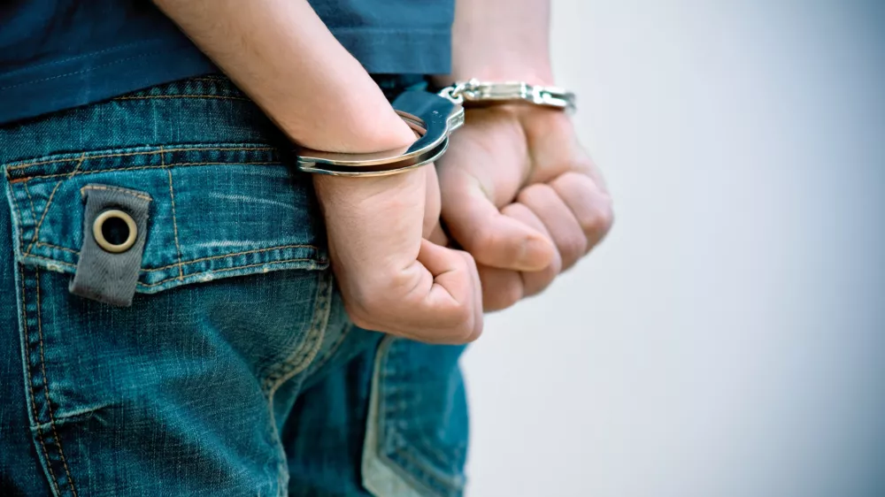 Young man in handcuffs