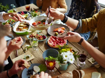 People sitting at dining table and eating
