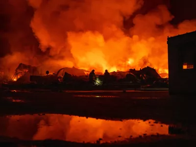 Firefighters put out a fire after Russian missiles hit a warehouse in Kyiv, Ukraine, Wednesday, Aug. 5, 2026. (AP Photo/Dan Bashakov)