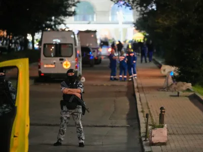 A policeman stands guard near the site where an improvised explosive device detonated at a restaurant in central Moscow, Saturday, Aug. 1, 2026. (AP Photo/Pavel Bednyakov)