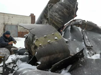 FILE PHOTO: A man photographs parts of an unidentified missile, which Ukrainian authorities believe to be made in North Korea and was used in a strike in Kharkiv earlier this week, amid Russia's attack on Ukraine, in Kharkiv, Ukraine January 6, 2024. REUTERS/Vyacheslav Madiyevskyy/File Photo