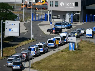 Police vehicles are parked at Leipzig/Halle Airport, where investigations are underway following the drone incident that occurred early Wednesday morning, in Schkeuditz, Germany, Thursday Aug. 6, 2026. (Hendrik Schmidt/dpa via AP)