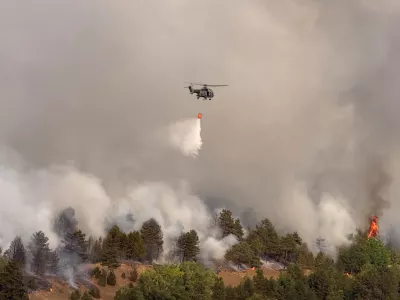 In this photograph made available by the Serbian Ministry of Interior, a Serbian Police helicopter battles a fire in Deliblatska Pescara (Deliblato Sands), 70 kilometers north-west of Belgrade, Serbia, on Wednesday, Aug. 5, 2026. (Serbian Ministry of Interior via AP)