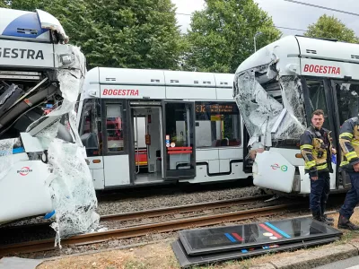 Emergency responders work at the scene of an accident where two trams collided in Gelsenkirchen, Germany, Thursday, Aug. 6, 2026. (AP Photo/Martin Meissner)