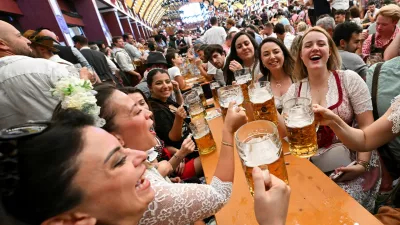 Visitors raise their beer mugs during the official opening day of the 190th Oktoberfest, the world's largest beer festival in Munich, Germany, September 20, 2025. REUTERS/Angelika Warmuth